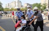 凤台交警用轮椅把受伤考生推进考场