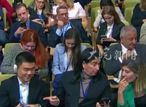徐德智向外国记者展示折叠手机 外国记者拿着体验 爱不释手 “现在已经是三折叠了，只有中国品牌有！”
