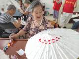 合肥高新区天乐中心开展“一伞一韵是拾遗 一笔一划连民心”活动